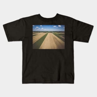 Aerial view of round hay bales on stubble under blue cloudy sky Kids T-Shirt